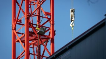a crane that is hanging from the side of a building