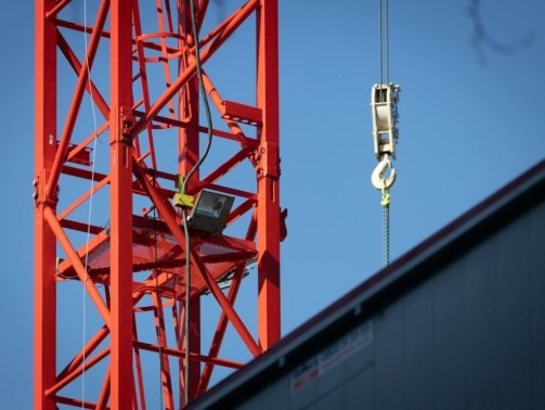 a crane that is hanging from the side of a building