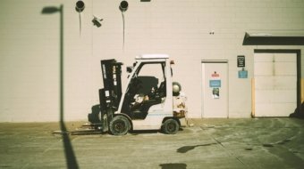 a forklift parked in front of a building