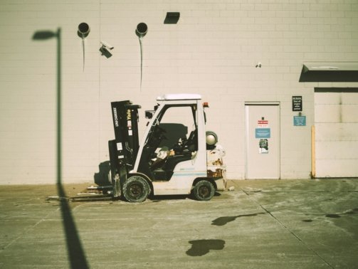 a forklift parked in front of a building