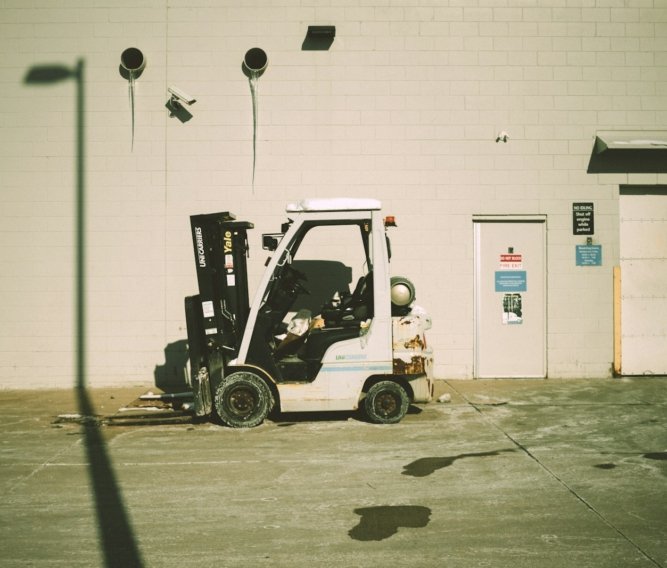 a forklift parked in front of a building