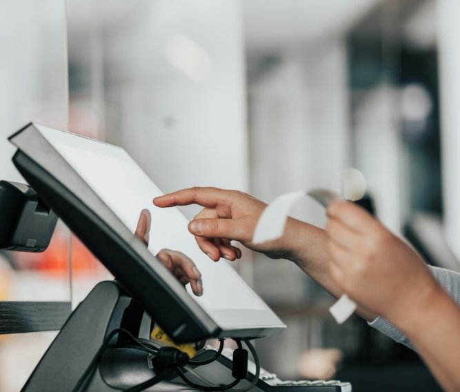 a person is using a pos machine in a store