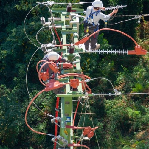 a man in a white shirt is on a high wire
