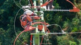 a man in a white shirt is on a high wire