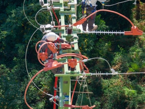 a man in a white shirt is on a high wire
